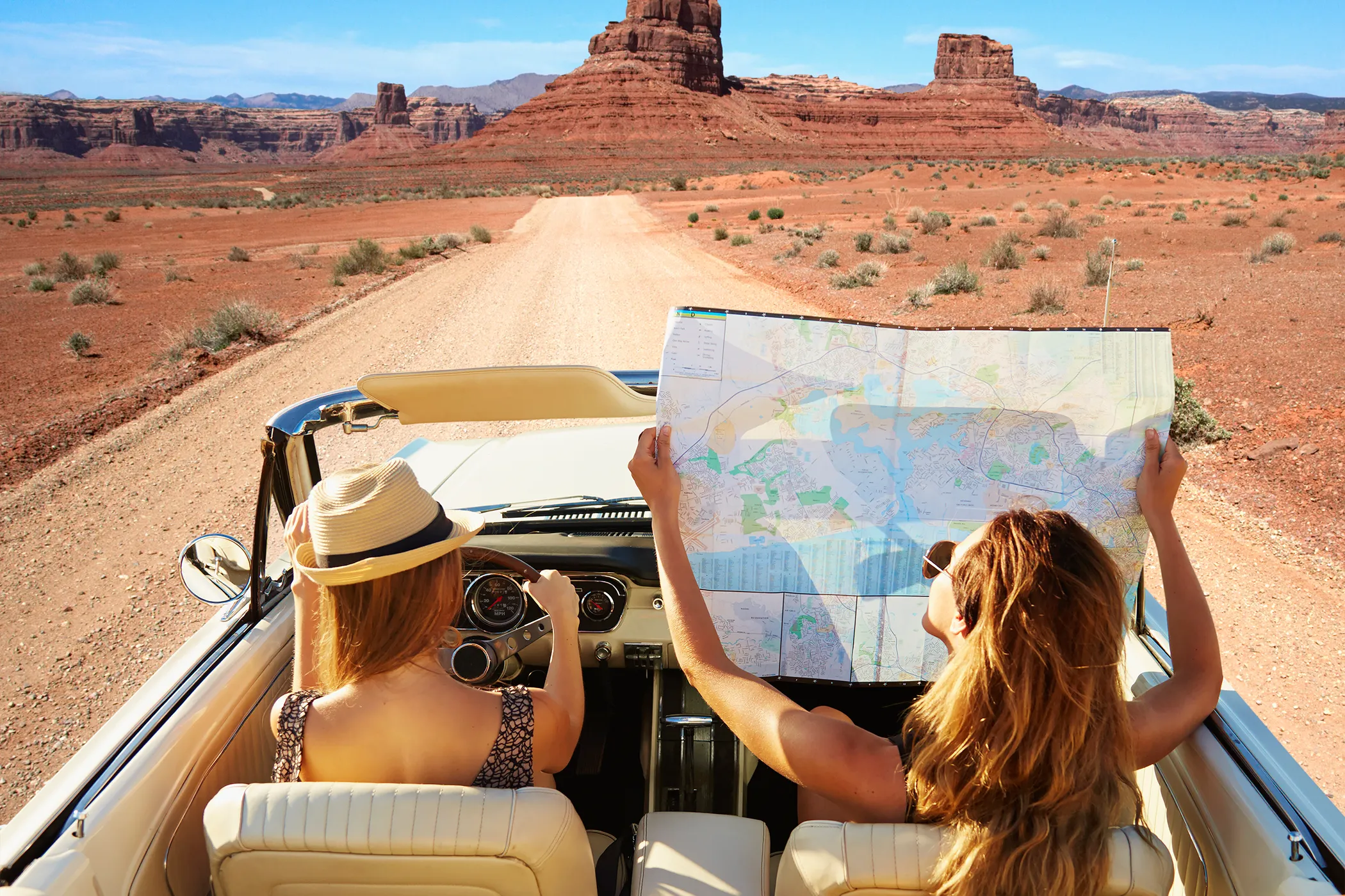 2 women traveling in jeep one is understanding map