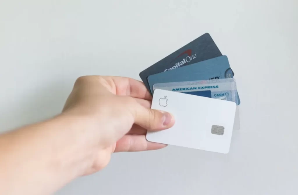 Hand holding credit cards, symbolizing credit debt.
