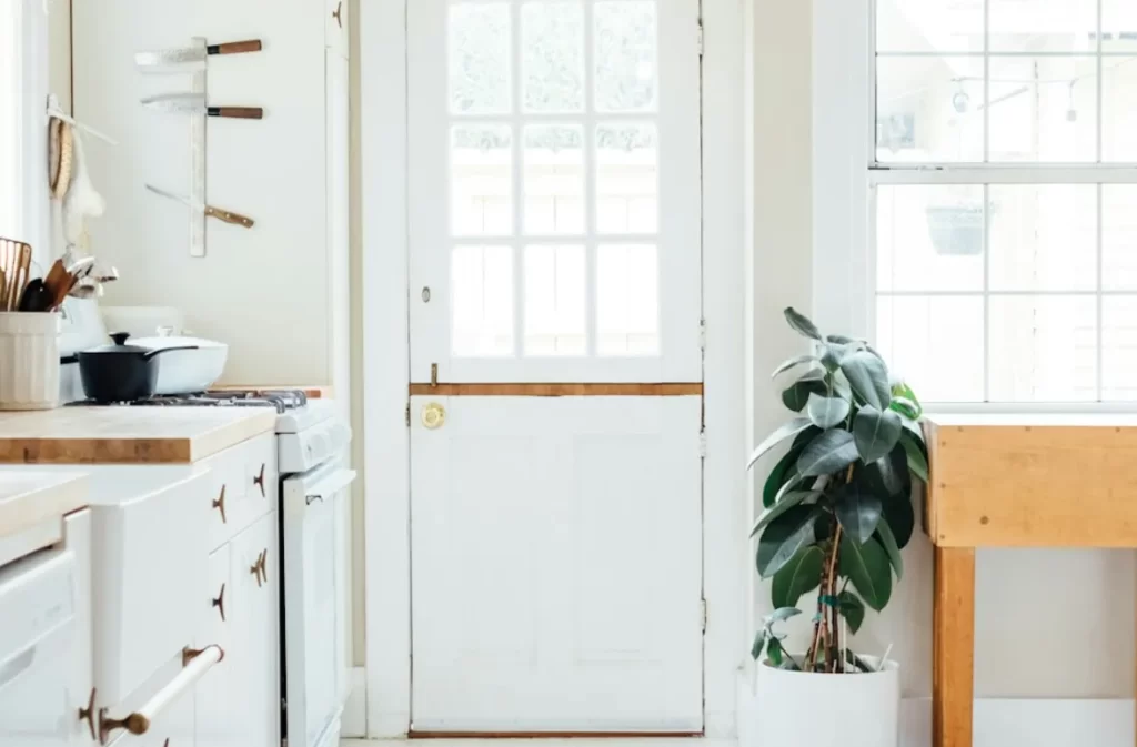 Bright kitchen with white cabinetry and a cozy aesthetic.