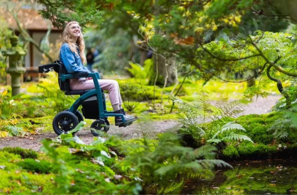 Woman in wheelchair enjoying a serene garden.