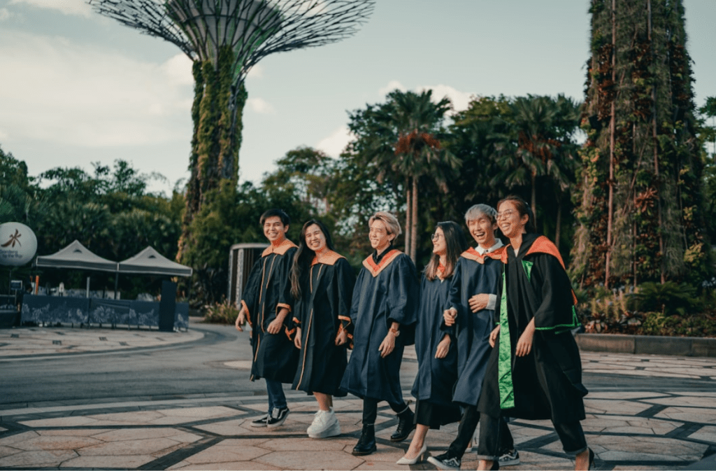 Psychology graduates celebrating outdoors.