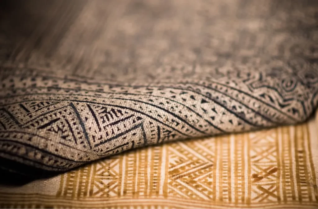 Close-up of patterned carpet texture in earthy tones.