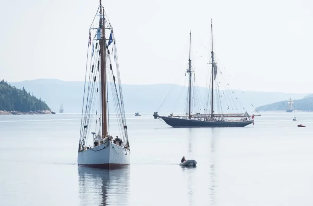 Sailing trip with classic boats on calm waters.