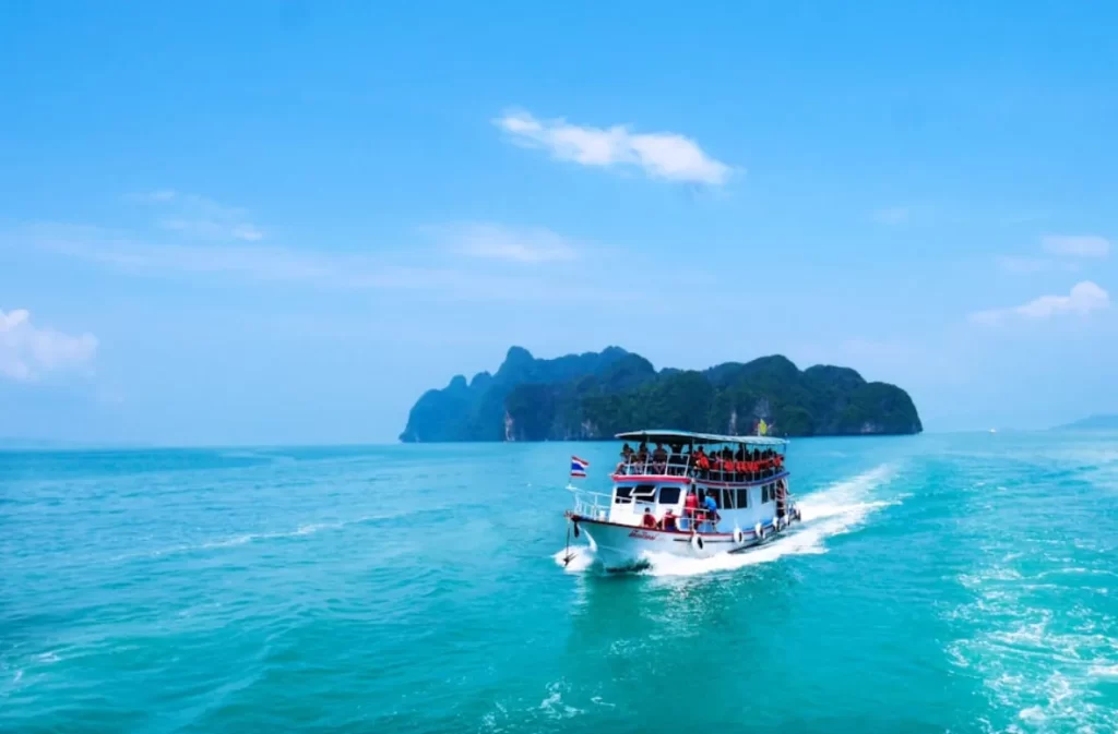 Sailing trip boat cruising past lush islands.