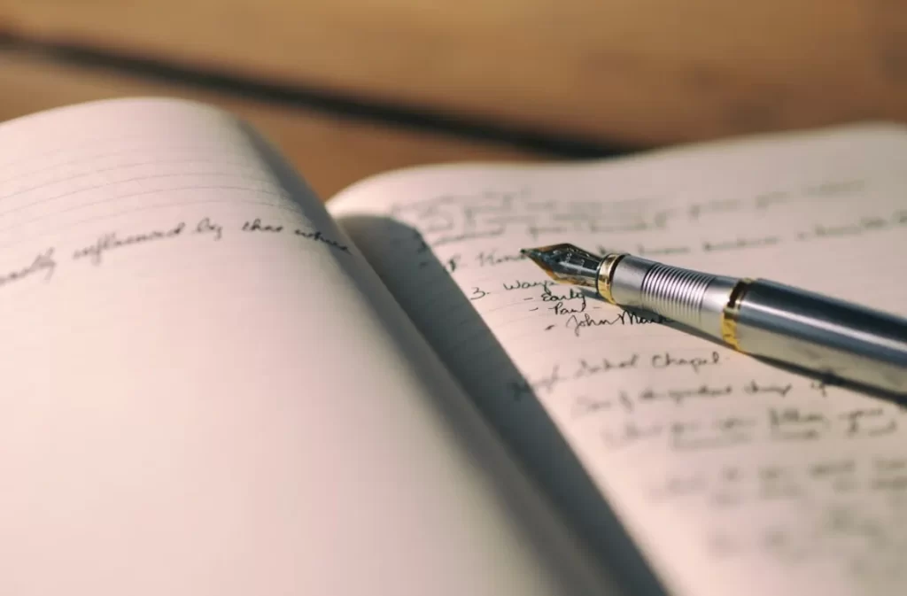 Handwriting in an open notebook for essay writing.