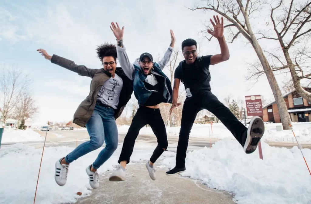 Group of young people jumping energetically.