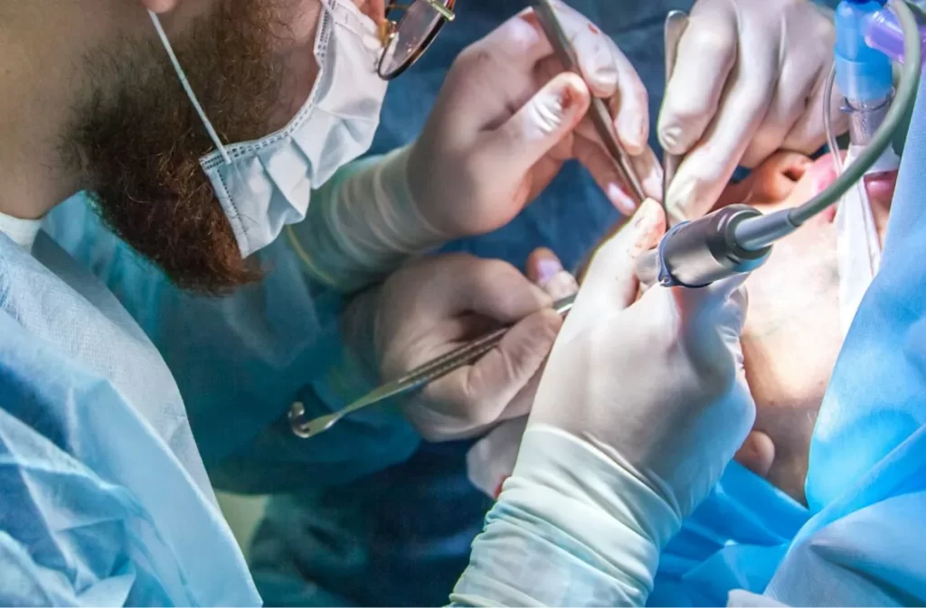 Dentists performing a surgical procedure in an operating room.