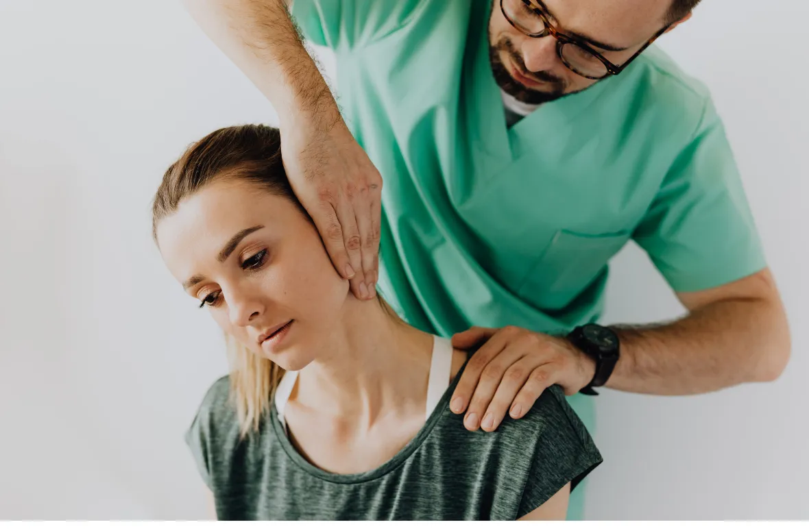 Chiropractor adjusting a woman's neck carefully.