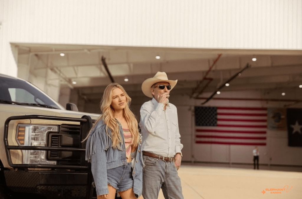 Michelle Randolph outdoors with a man in a cowboy hat near a truck.