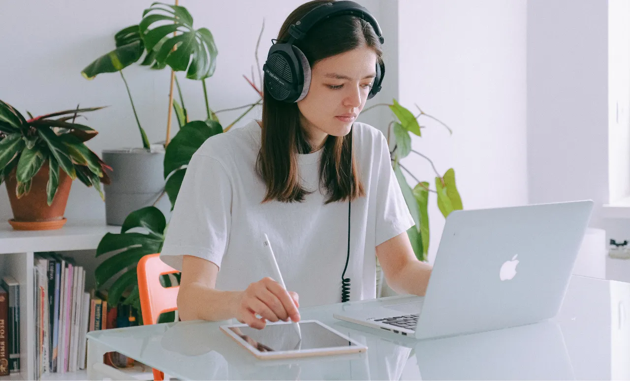 Person working on MacBook Overheating at a study desk